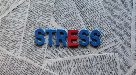 the word stress with a newspaper in the background