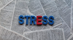 the word stress with a newspaper in the background